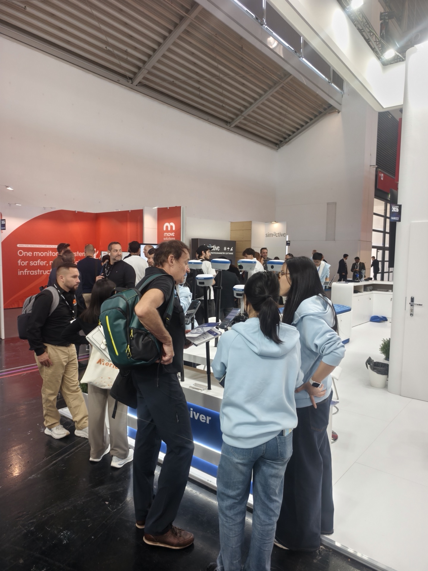 Visitors watching a TOKNAV equipment demonstration at Intergeo 2026
