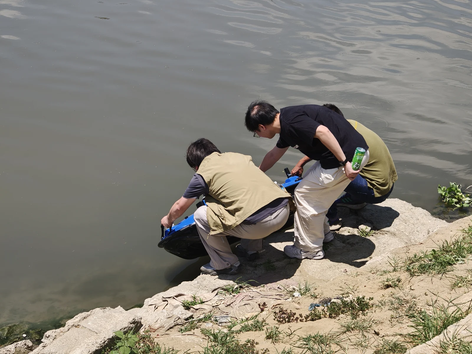 Team handling a TOKNAV TBoat at the shoreline during field testing in the Philippines