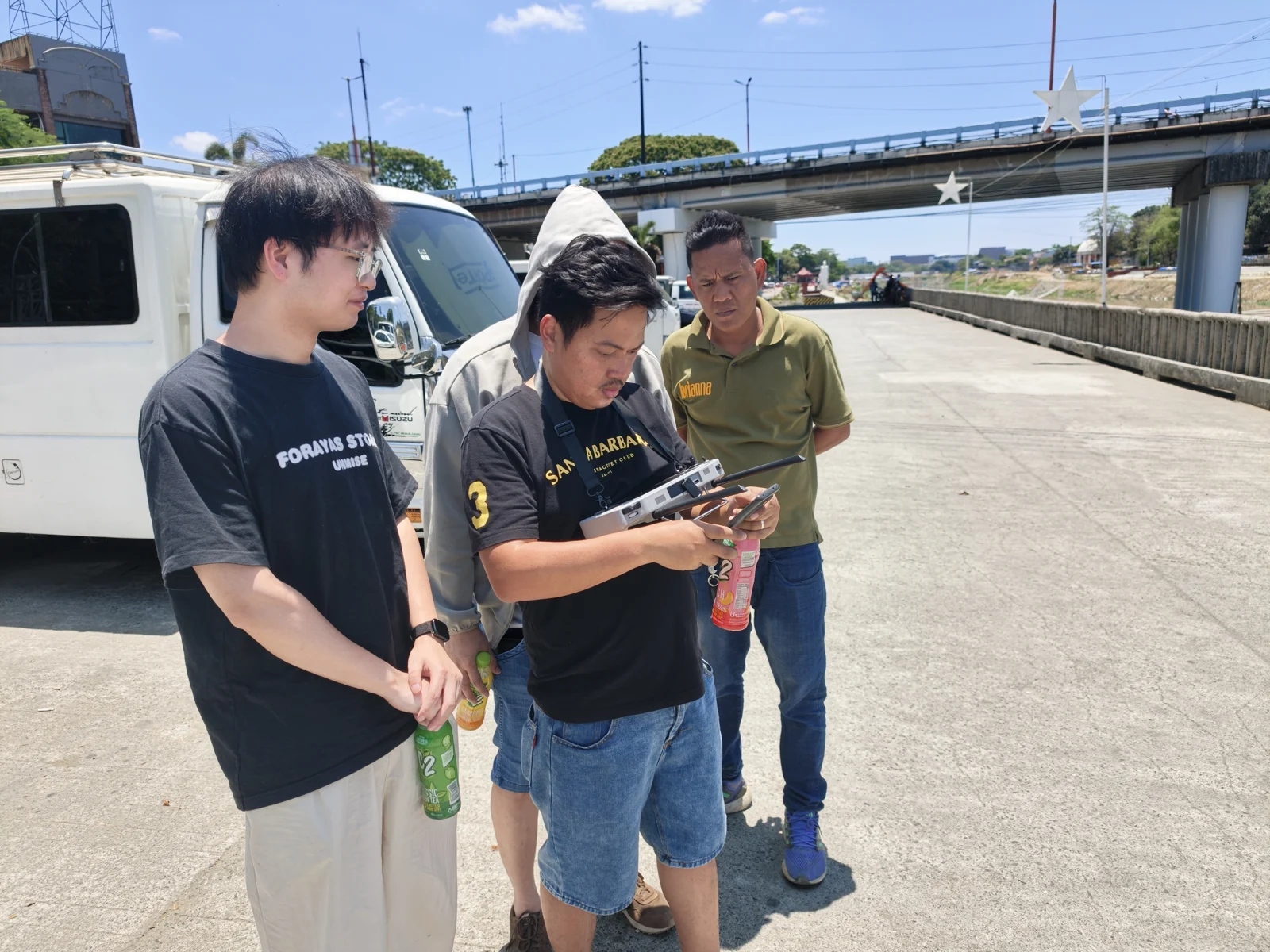 Field team using a handheld controller during a TOKNAV TBoat test in the Philippines